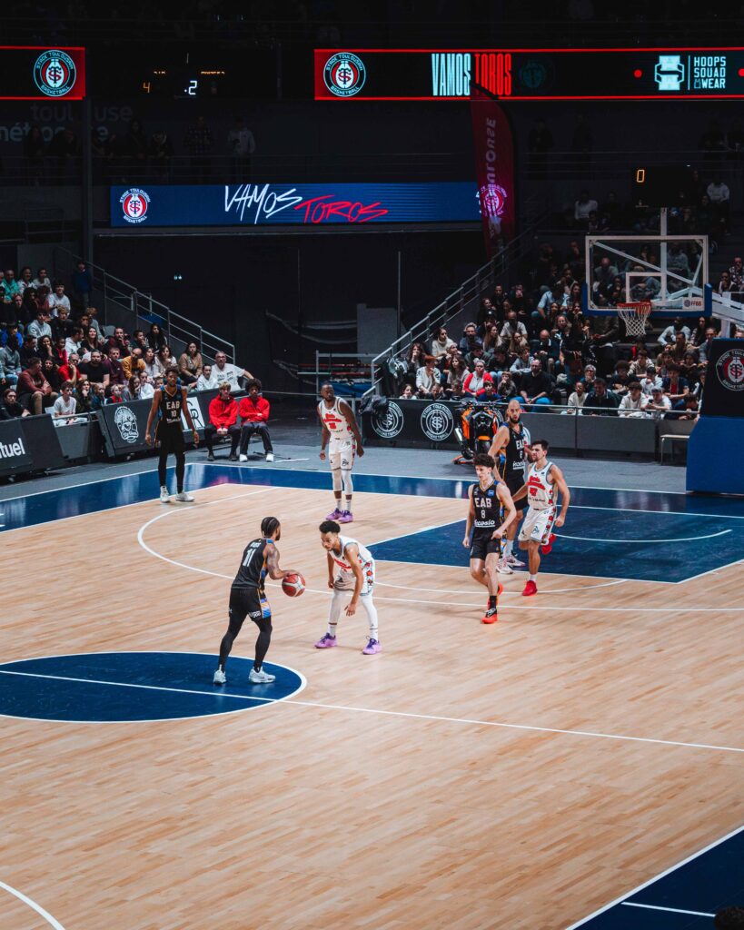 a basketball game with people watching