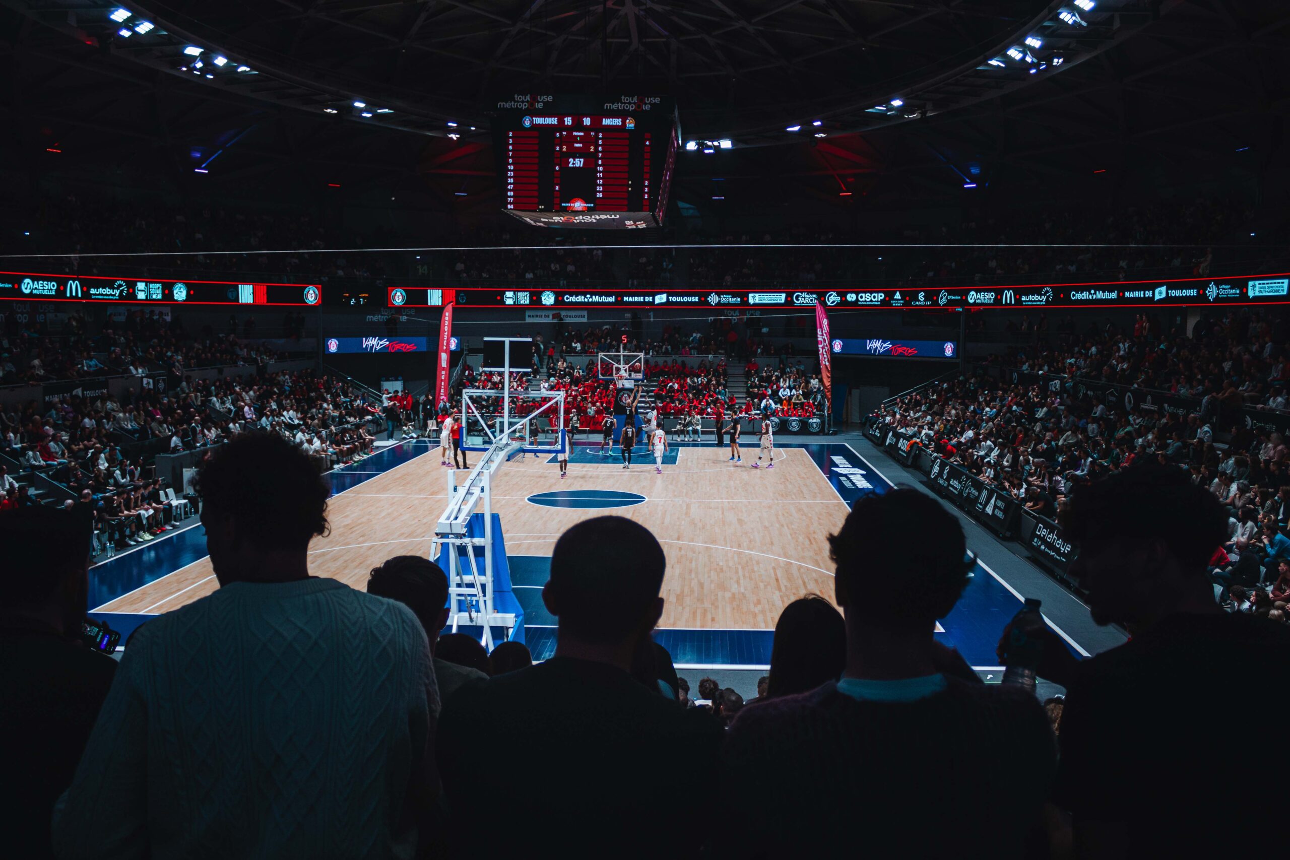 a basketball court with people watching