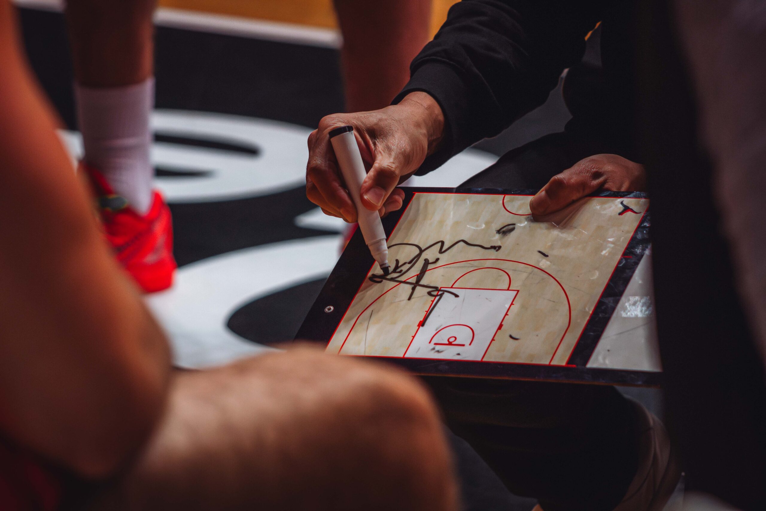 a coach drawing on a board