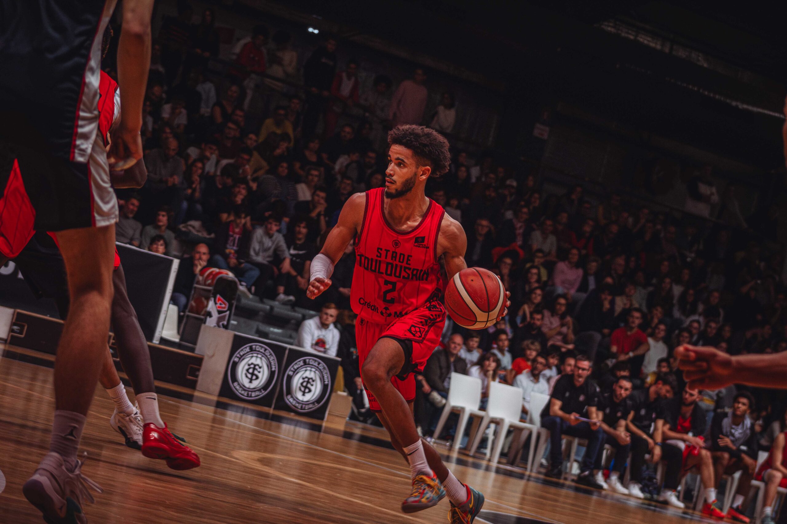a basketball player dribbling a ball