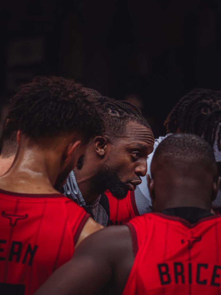 a group of men in a basketball uniform